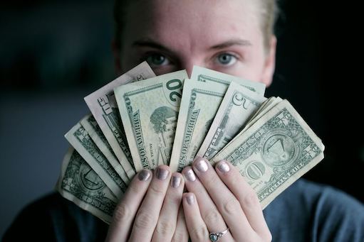 woman holding cash in hands